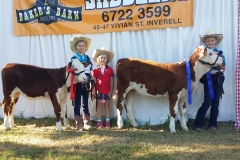 Kirsty - holding clover on left Isla - holding Minty Skye in middle. Northern Youth Hereford heifer show in inverell